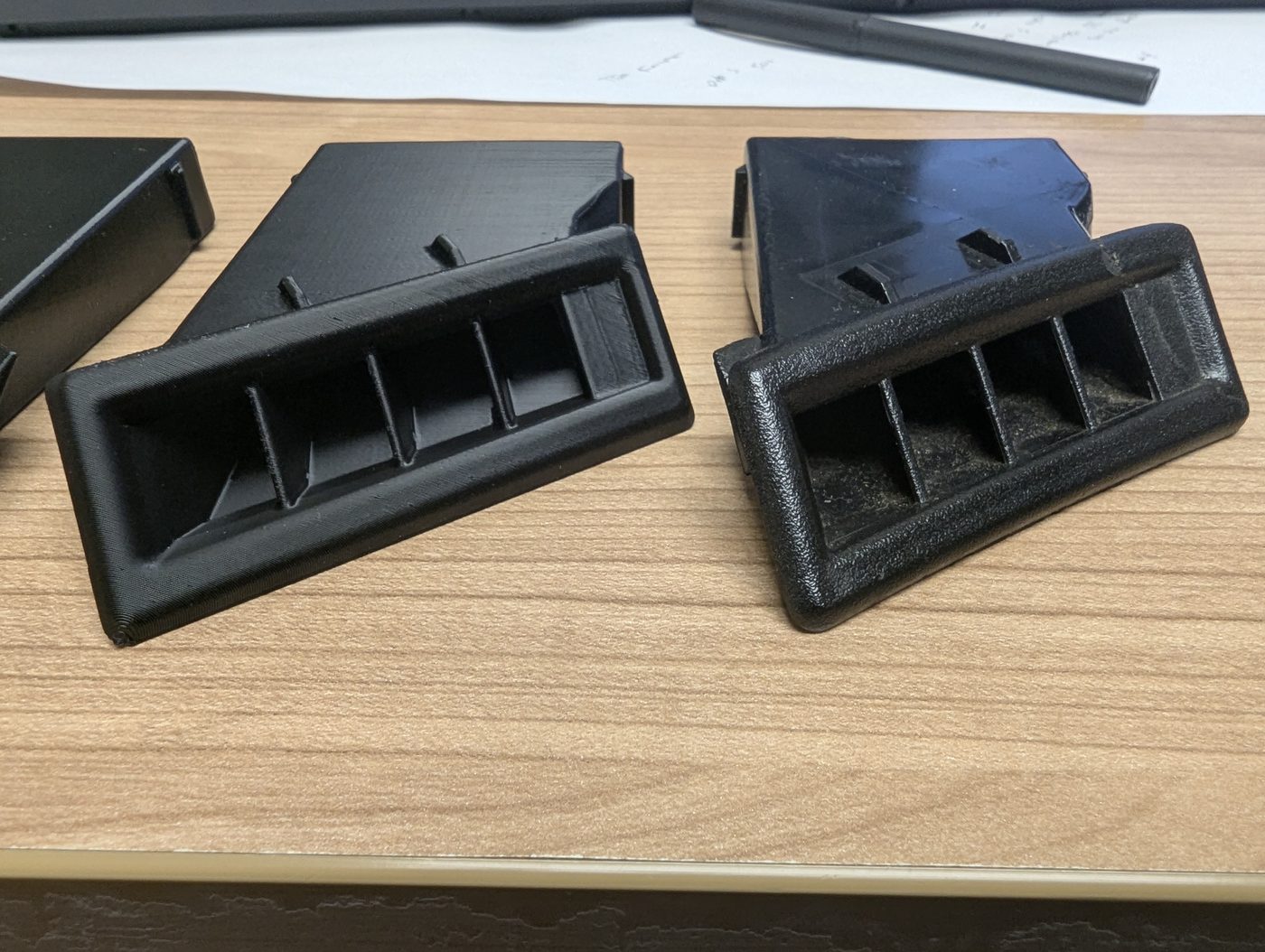 3D printed part next to OEM original